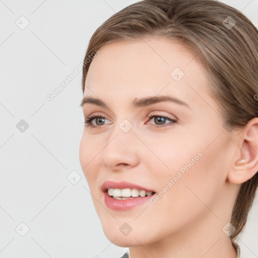 Joyful white young-adult female with long  brown hair and grey eyes