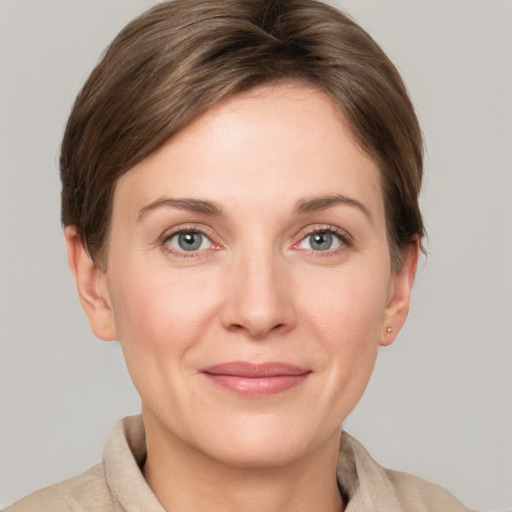 Joyful white young-adult female with short  brown hair and grey eyes