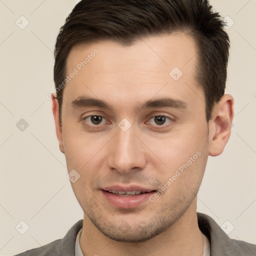 Joyful white young-adult male with short  brown hair and brown eyes