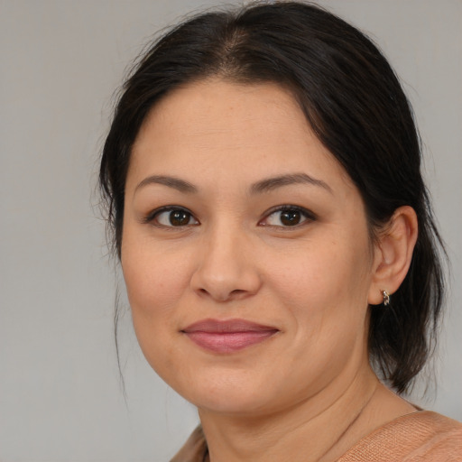 Joyful asian young-adult female with medium  brown hair and brown eyes