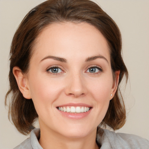 Joyful white young-adult female with medium  brown hair and blue eyes