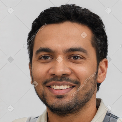 Joyful latino young-adult male with short  black hair and brown eyes