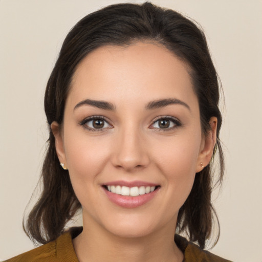 Joyful white young-adult female with medium  brown hair and brown eyes