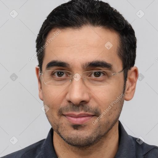 Joyful white young-adult male with short  black hair and brown eyes