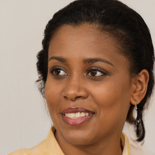 Joyful black young-adult female with medium  brown hair and brown eyes