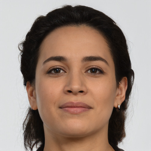 Joyful latino young-adult female with medium  brown hair and brown eyes