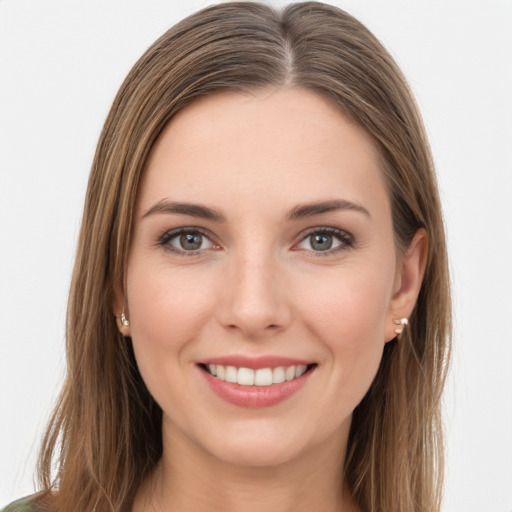 Joyful white young-adult female with long  brown hair and green eyes