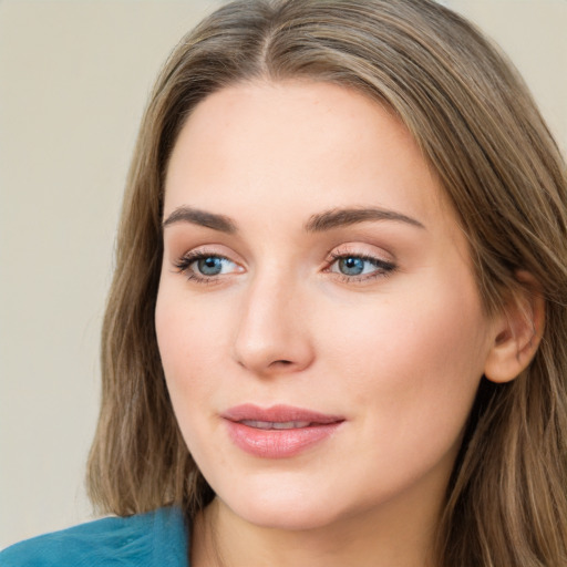 Joyful white young-adult female with long  brown hair and blue eyes