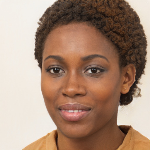 Joyful black young-adult female with short  brown hair and brown eyes