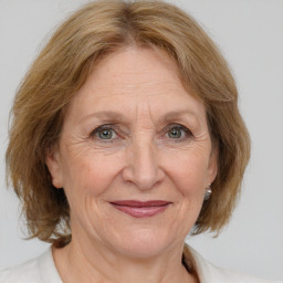 Joyful white middle-aged female with medium  brown hair and brown eyes