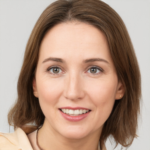 Joyful white young-adult female with medium  brown hair and brown eyes