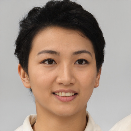 Joyful asian young-adult female with short  brown hair and brown eyes
