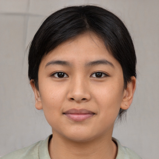 Joyful asian young-adult female with short  brown hair and brown eyes