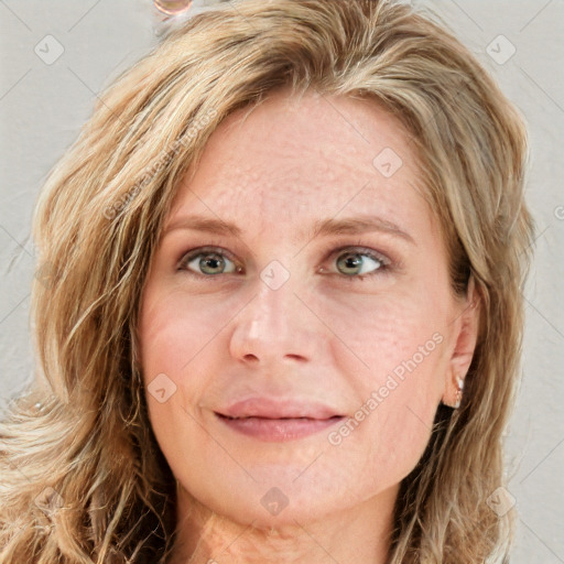 Joyful white young-adult female with long  brown hair and blue eyes