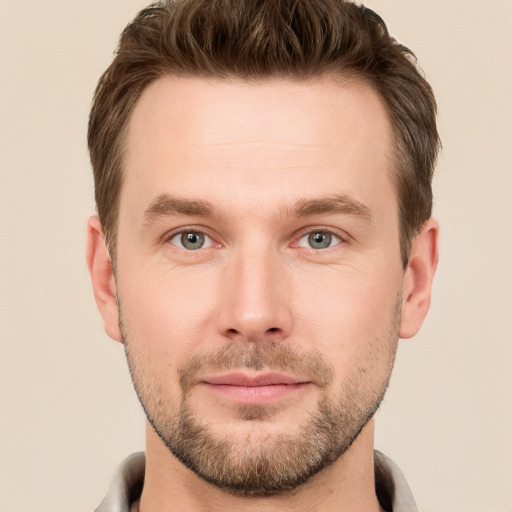 Joyful white young-adult male with short  brown hair and grey eyes