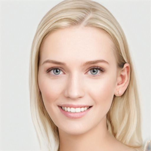 Joyful white young-adult female with long  brown hair and blue eyes