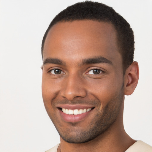 Joyful black young-adult male with short  brown hair and brown eyes