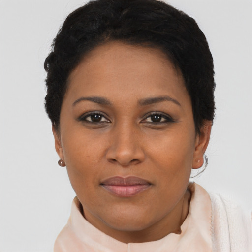Joyful black young-adult female with short  brown hair and brown eyes