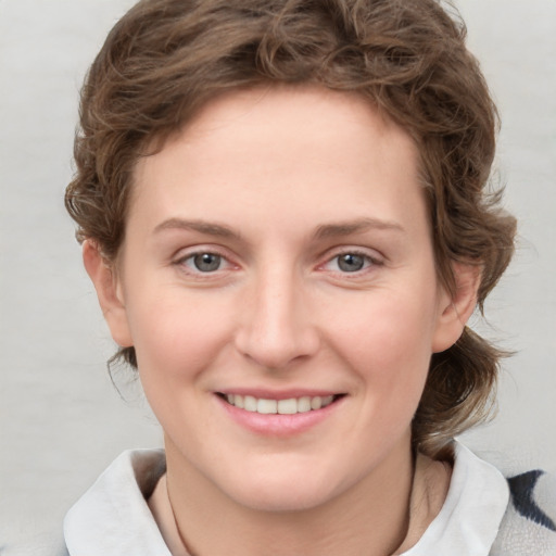 Joyful white young-adult female with medium  brown hair and blue eyes