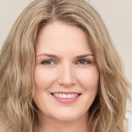 Joyful white young-adult female with long  brown hair and green eyes