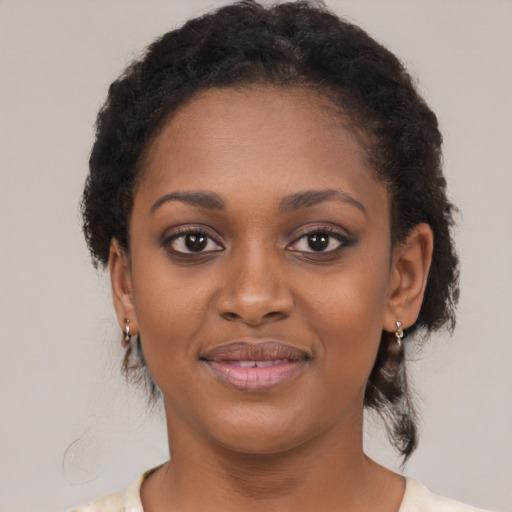 Joyful black young-adult female with medium  brown hair and brown eyes