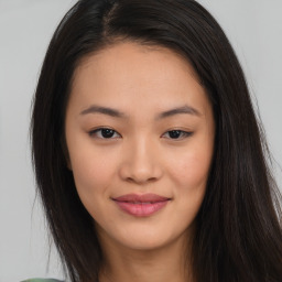 Joyful asian young-adult female with long  brown hair and brown eyes