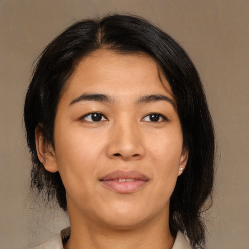 Joyful asian young-adult female with medium  brown hair and brown eyes