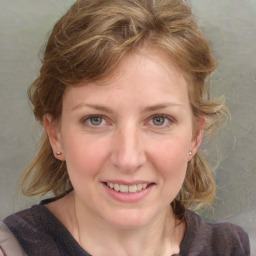 Joyful white young-adult female with medium  brown hair and blue eyes