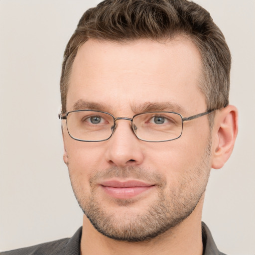 Joyful white adult male with short  brown hair and grey eyes