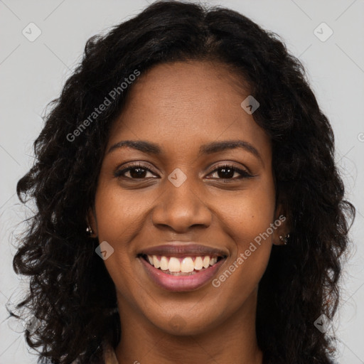 Joyful black young-adult female with long  brown hair and brown eyes