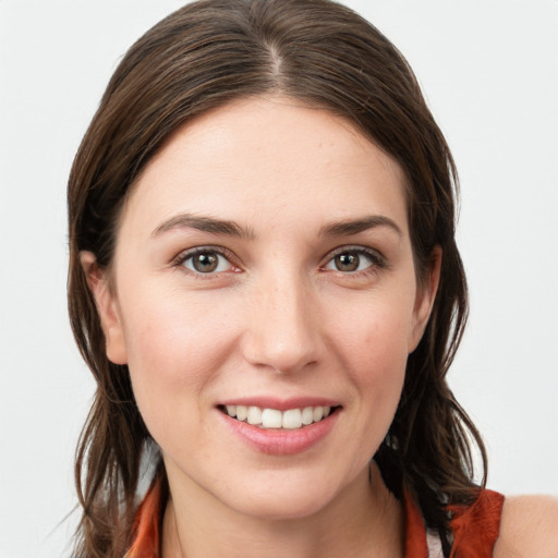 Joyful white young-adult female with medium  brown hair and grey eyes