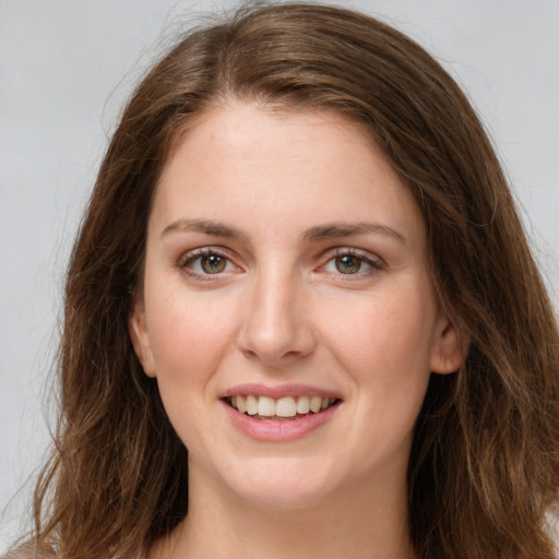 Joyful white young-adult female with long  brown hair and grey eyes