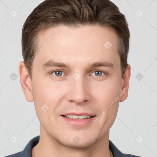 Joyful white young-adult male with short  brown hair and grey eyes