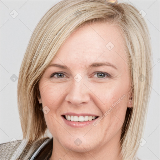 Joyful white young-adult female with medium  brown hair and blue eyes