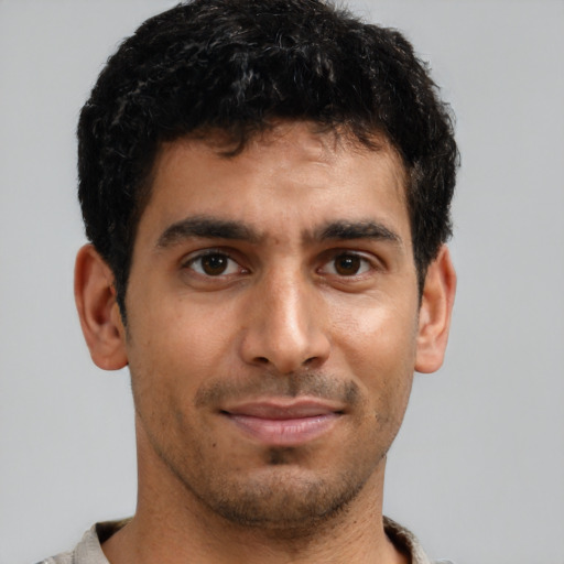 Joyful latino young-adult male with short  brown hair and brown eyes