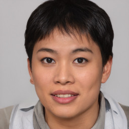 Joyful asian young-adult female with short  brown hair and brown eyes