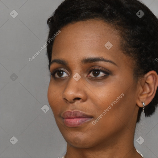 Joyful black young-adult female with short  brown hair and brown eyes