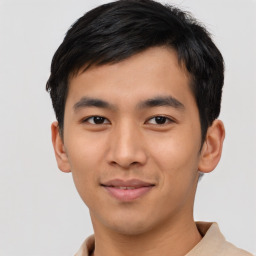 Joyful asian young-adult male with short  black hair and brown eyes