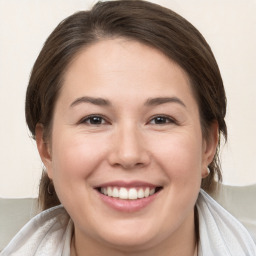 Joyful white young-adult female with medium  brown hair and brown eyes