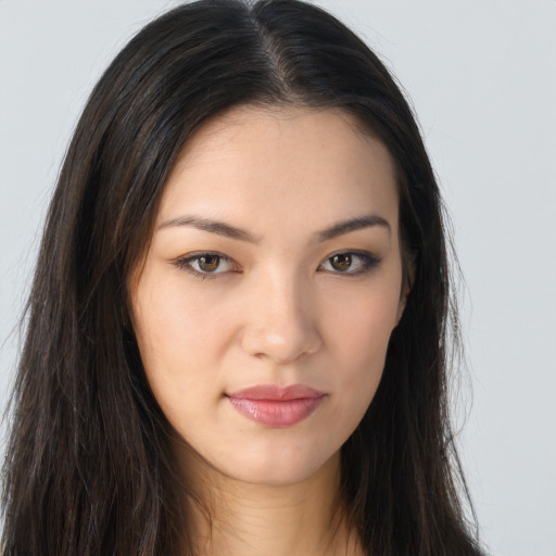 Joyful asian young-adult female with long  brown hair and brown eyes