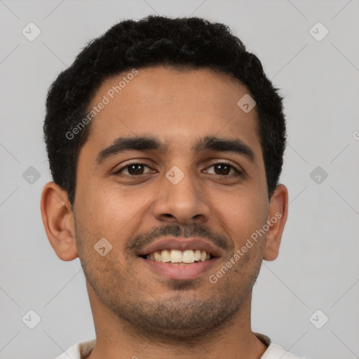 Joyful latino young-adult male with short  black hair and brown eyes