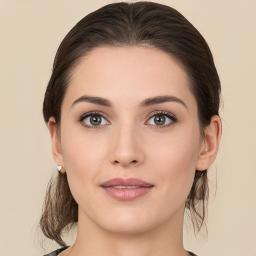 Joyful white young-adult female with medium  brown hair and brown eyes