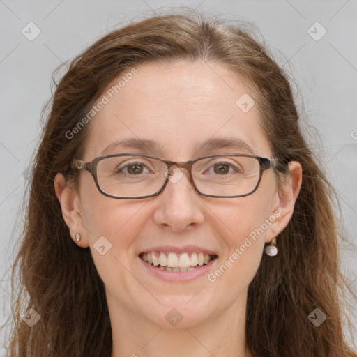 Joyful white adult female with long  brown hair and grey eyes