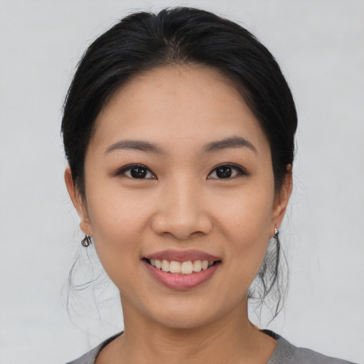 Joyful asian young-adult female with medium  black hair and brown eyes