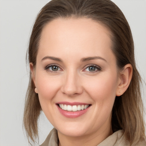 Joyful white young-adult female with medium  brown hair and grey eyes