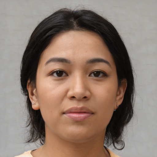 Joyful asian young-adult female with medium  black hair and brown eyes