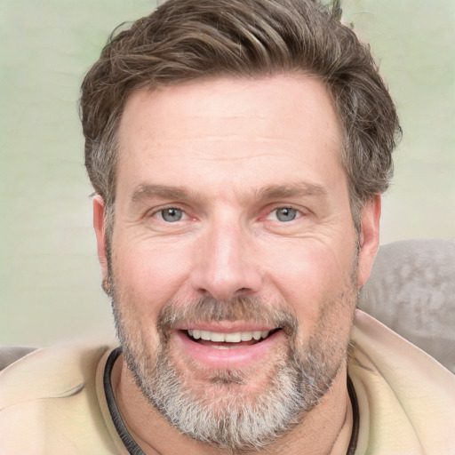 Joyful white adult male with short  brown hair and grey eyes