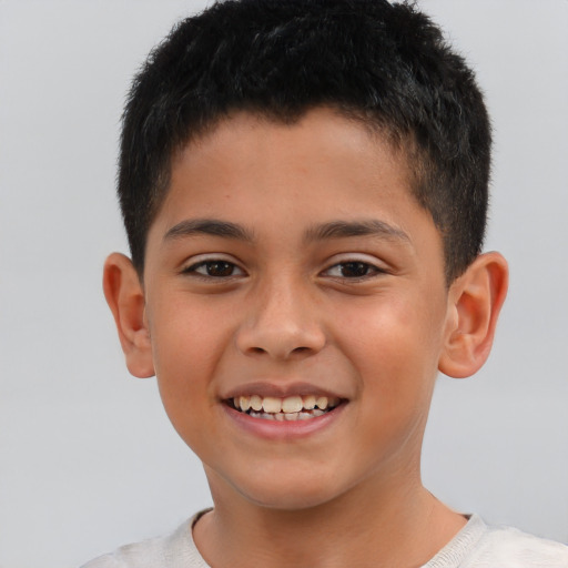 Joyful latino child male with short  brown hair and brown eyes