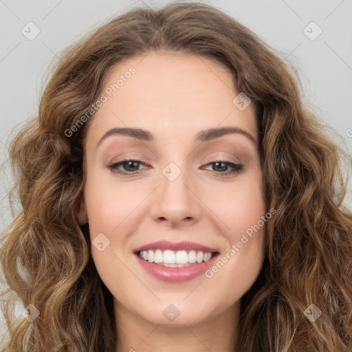 Joyful white young-adult female with long  brown hair and green eyes