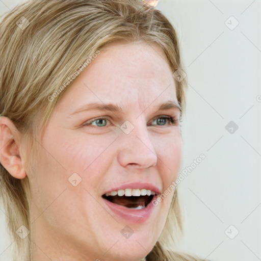 Joyful white young-adult female with medium  brown hair and blue eyes